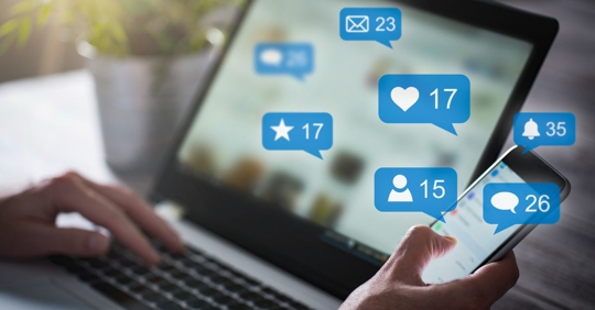 person on computer looking at social media